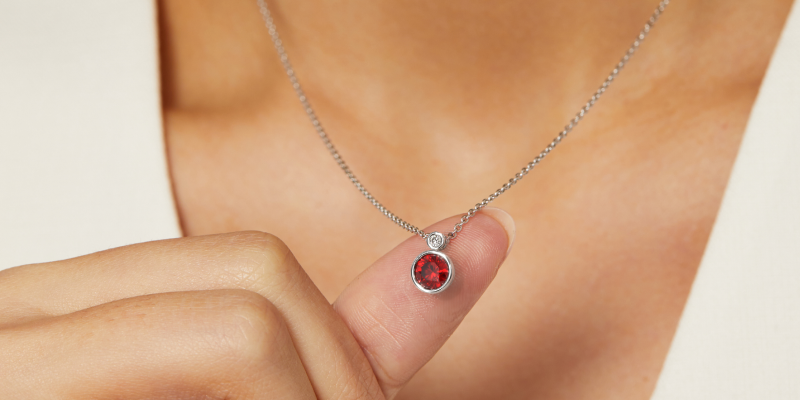 Women wearing a gemstone pendant